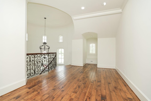 764 Kuhlman Rd, Hunters Creek Village, TX 77024 - empty room with arched walkways, crown molding, hardwood / wood-style floors, and a towering ceiling