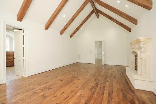 764 Kuhlman Rd, Hunters Creek Village, TX 77024 - unfurnished living room featuring beam ceiling, recessed lighting, wood-type flooring, a premium fireplace, and high vaulted ceiling