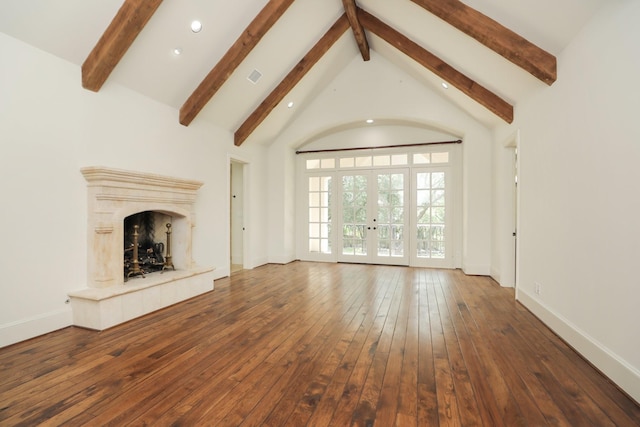 764 Kuhlman Rd, Hunters Creek Village, TX 77024 - unfurnished living room featuring beam ceiling, recessed lighting, wood-type flooring, a premium fireplace, and french doors
