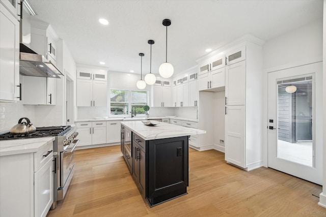 52 Indian Clover, The Woodlands, TX 77381 - kitchen with white cabinets, stainless steel stove, and recessed lighting
