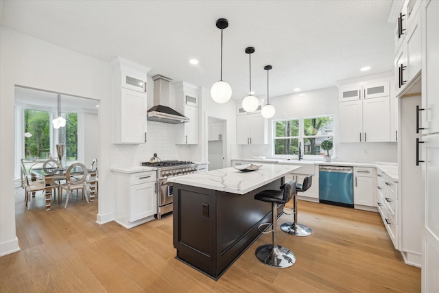 52 Indian Clover, The Woodlands, TX 77381 - kitchen featuring light wood finished floors, high end stainless steel range, white cabinetry, and recessed lighting