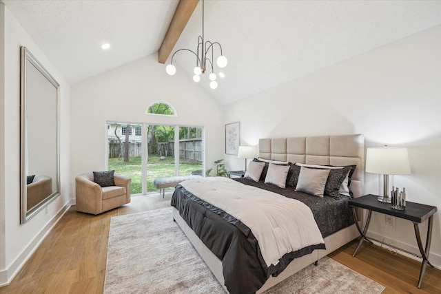 52 Indian Clover, The Woodlands, TX 77381 - bedroom with beam ceiling, wood finished floors, high vaulted ceiling, and a chandelier