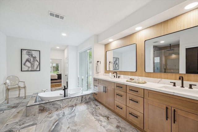 52 Indian Clover, The Woodlands, TX 77381 - ensuite bathroom featuring marble tiled flooring, double vanity, a bathtub, an enclosed shower, and recessed lighting