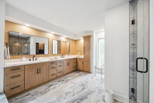 52 Indian Clover, The Woodlands, TX 77381 - bathroom featuring marble tiled flooring, double vanity, a stall shower, and recessed lighting