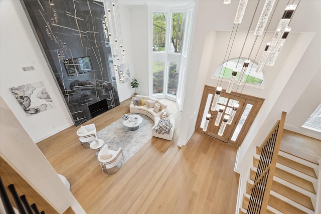 52 Indian Clover, The Woodlands, TX 77381 - living area with a towering ceiling, wood finished floors, and stairway