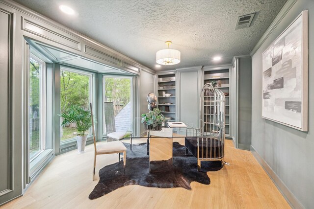 52 Indian Clover, The Woodlands, TX 77381 - office area with light wood-style floors, built in features, crown molding, recessed lighting, and a textured ceiling
