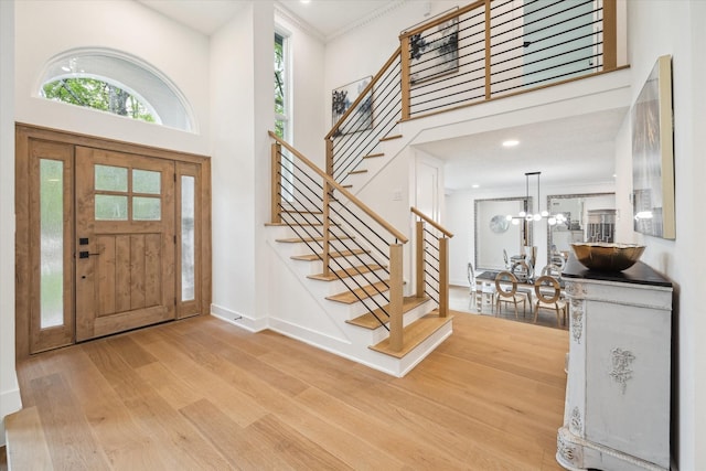 52 Indian Clover, The Woodlands, TX 77381 - foyer entrance with wood finished floors, stairs, a high ceiling, healthy amount of natural light, and a chandelier