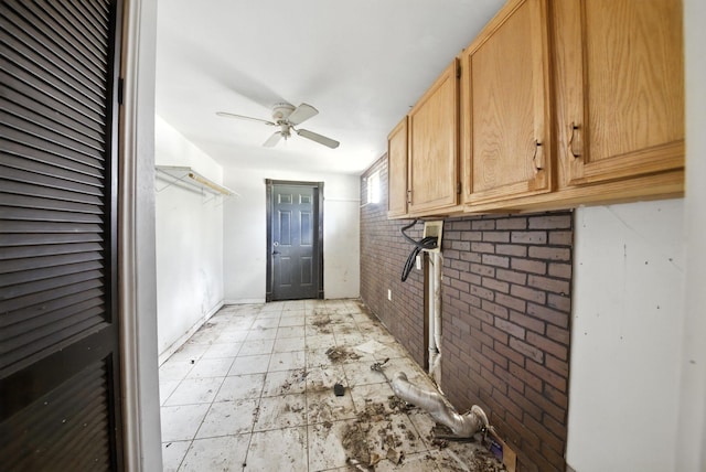 3819 Galway Ln, Houston, TX 77080 - laundry area with brick wall, a ceiling fan, and cabinet space