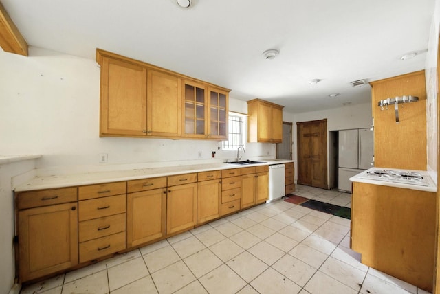 3819 Galway Ln, Houston, TX 77080 - kitchen with white appliances, light countertops, glass insert cabinets, light tile patterned flooring, and brown cabinetry