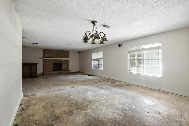 3819 Galway Ln, Houston, TX 77080 - unfurnished living room with a chandelier, concrete floors, a textured ceiling, and a brick fireplace