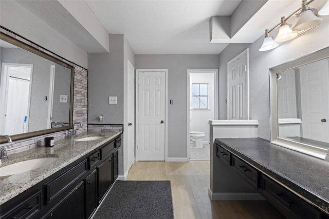 727 Baltic Ln, Houston, TX 77090 - bathroom with double vanity and wood finished floors