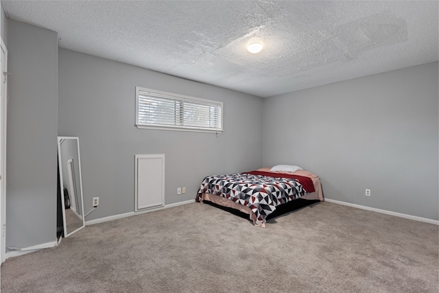 727 Baltic Ln, Houston, TX 77090 - carpeted bedroom featuring a textured ceiling and baseboards
