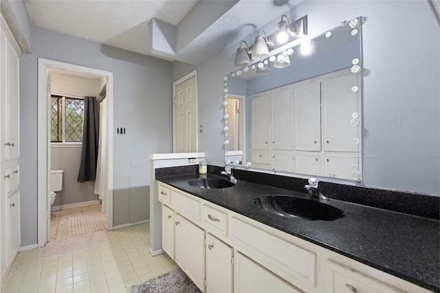 727 Baltic Ln, Houston, TX 77090 - bathroom with double vanity and tile patterned floors