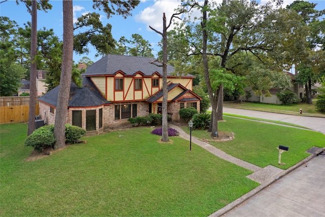 727 Baltic Ln, Houston, TX 77090 - tudor house featuring roof with shingles and brick siding