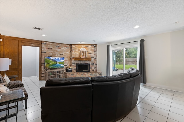 727 Baltic Ln, Houston, TX 77090 - living room with light tile patterned floors, a textured ceiling, a fireplace, and recessed lighting