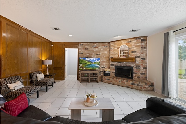 727 Baltic Ln, Houston, TX 77090 - living room featuring a textured ceiling, light tile patterned flooring, and a fireplace