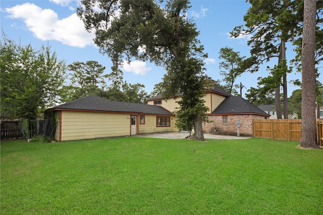 727 Baltic Ln, Houston, TX 77090 - rear view of house featuring a fenced backyard, a patio, roof with shingles, and a gate
