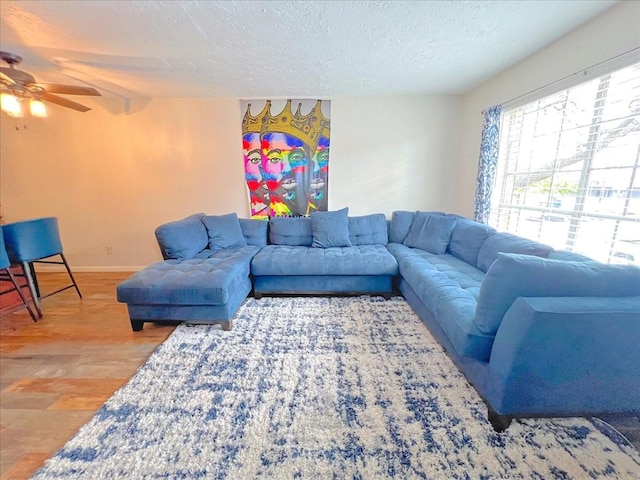 6305 Westward St Unit 106, Houston, TX 77081 - living room featuring a textured ceiling, ceiling fan, and wood finished floors