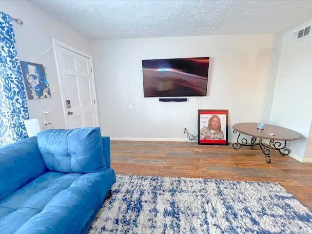 6305 Westward St Unit 106, Houston, TX 77081 - living room with wood finished floors and a textured ceiling