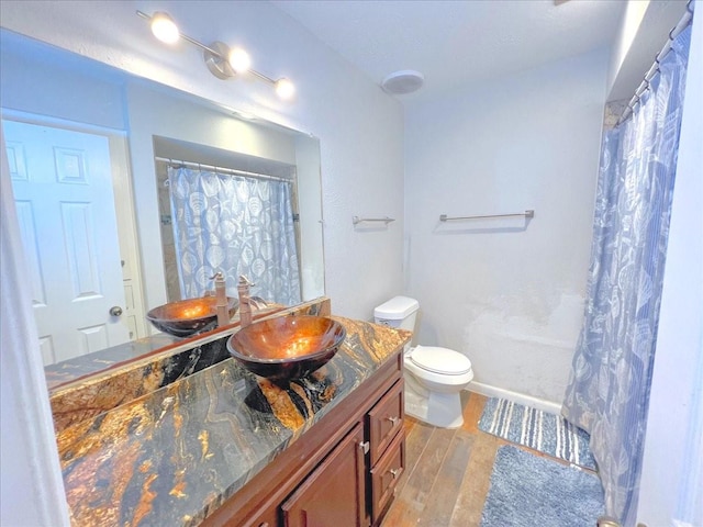 6305 Westward St Unit 106, Houston, TX 77081 - bathroom featuring wood finished floors, vanity, and curtained shower