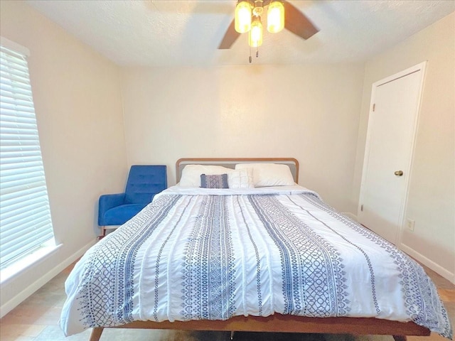 6305 Westward St Unit 106, Houston, TX 77081 - bedroom with baseboards and ceiling fan