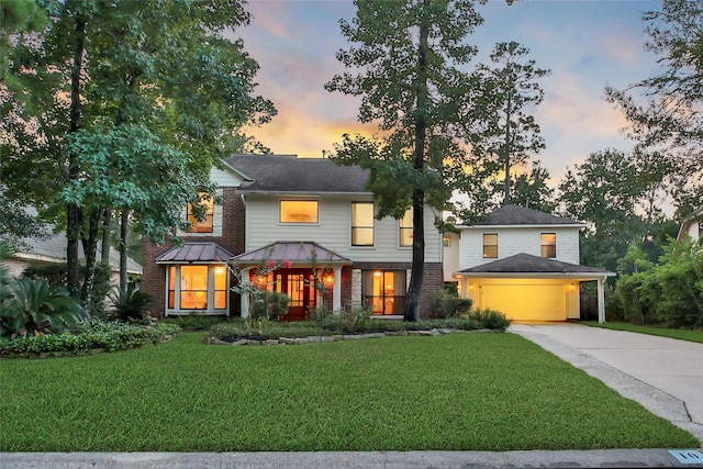 10 Featherfall Pl, Spring, TX 77381 - view of front facade with concrete driveway, a front lawn, brick siding, and an attached garage