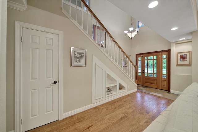 10 Featherfall Pl, Spring, TX 77381 - entryway with light wood-style flooring, stairs, a high ceiling, a chandelier, and recessed lighting