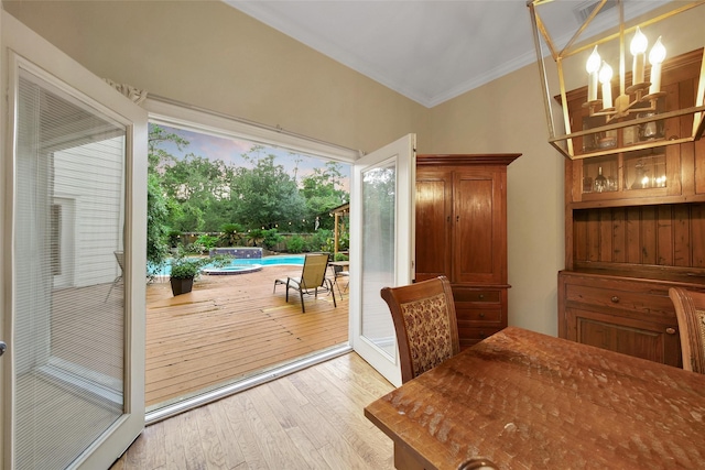 10 Featherfall Pl, Spring, TX 77381 - dining area with ornamental molding, hardwood / wood-style flooring, and a chandelier