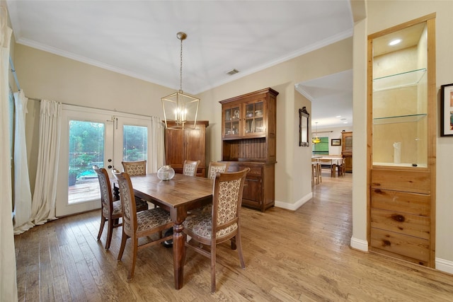10 Featherfall Pl, Spring, TX 77381 - dining space featuring light wood-style flooring, ornamental molding, a chandelier, and french doors