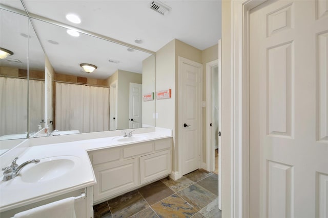 10 Featherfall Pl, Spring, TX 77381 - bathroom with double vanity and a shower with shower curtain