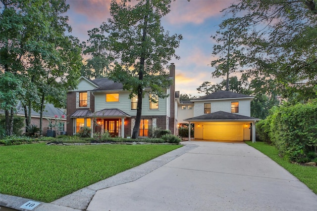 10 Featherfall Pl, Spring, TX 77381 - view of front facade featuring driveway, a front yard, a chimney, and brick siding