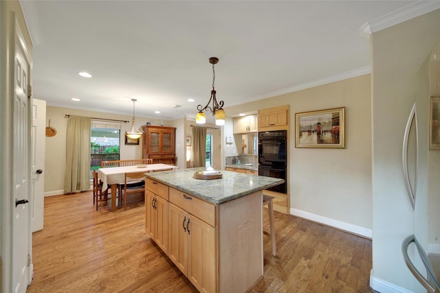 10 Featherfall Pl, Spring, TX 77381 - kitchen with a center island, light brown cabinets, light wood finished floors, fridge, and ornamental molding