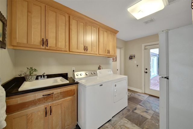 10 Featherfall Pl, Spring, TX 77381 - laundry room with washing machine and dryer, light stone finish flooring, and cabinet space