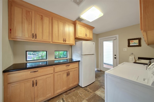 10 Featherfall Pl, Spring, TX 77381 - laundry room featuring washing machine and dryer and stone finish flooring