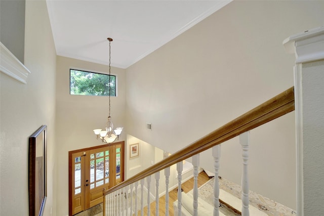 10 Featherfall Pl, Spring, TX 77381 - foyer entrance featuring a chandelier, stairway, a towering ceiling, wood finished floors, and ornamental molding