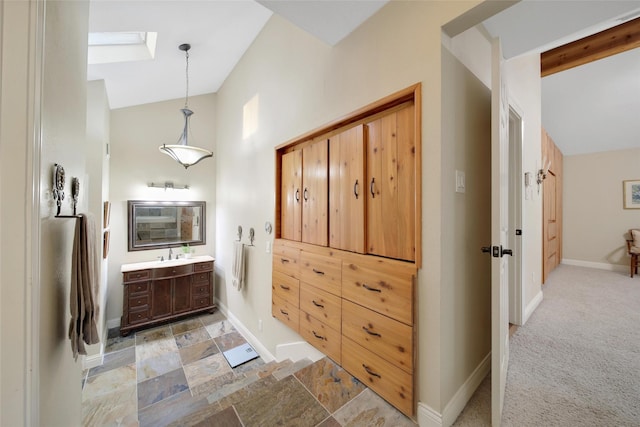 10 Featherfall Pl, Spring, TX 77381 - bathroom featuring lofted ceiling, vanity, and a skylight