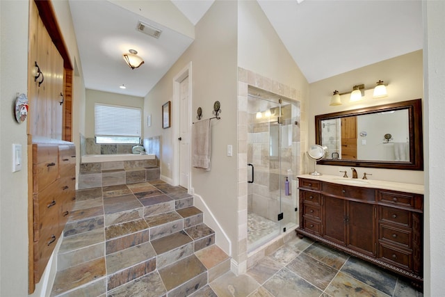 10 Featherfall Pl, Spring, TX 77381 - bathroom featuring a bath, vaulted ceiling, vanity, a stall shower, and stone tile flooring