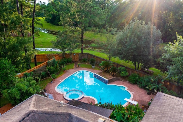 10 Featherfall Pl, Spring, TX 77381 - view of pool with a fenced backyard, a pool with connected hot tub, and a diving board