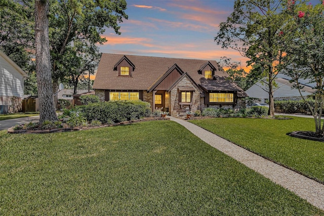 5934 Foresthaven Dr, Houston, TX 77066 - view of front of house with a front yard, stone siding, and roof with shingles