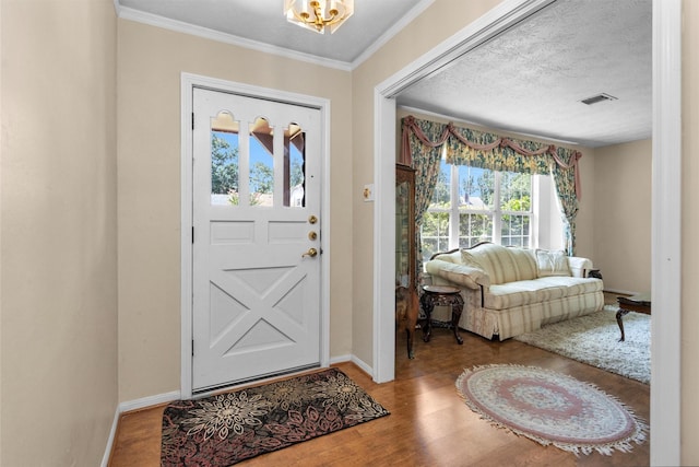 5934 Foresthaven Dr, Houston, TX 77066 - entryway featuring wood finished floors, a chandelier, and crown molding