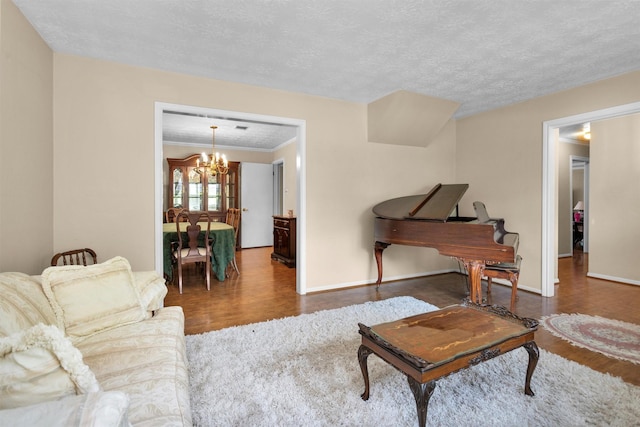 5934 Foresthaven Dr, Houston, TX 77066 - living area featuring wood finished floors, a chandelier, a textured ceiling, and crown molding