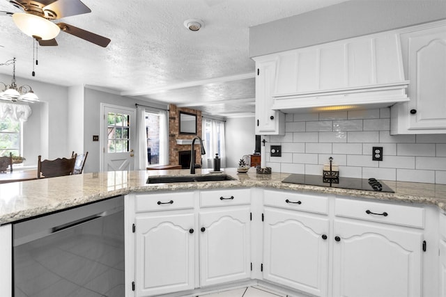 5934 Foresthaven Dr, Houston, TX 77066 - kitchen featuring a textured ceiling, stainless steel dishwasher, premium range hood, healthy amount of natural light, and a peninsula