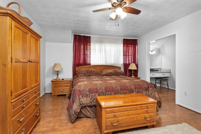 5934 Foresthaven Dr, Houston, TX 77066 - bedroom featuring a textured ceiling, wood finished floors, and a ceiling fan