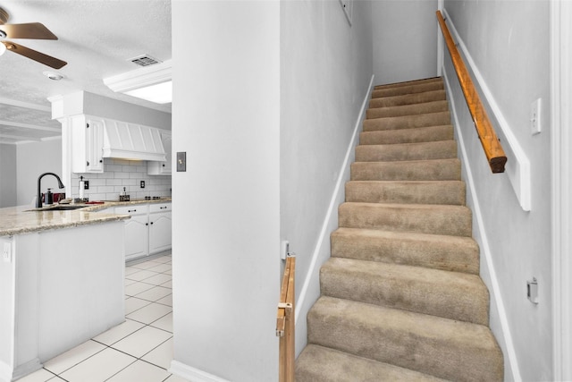 5934 Foresthaven Dr, Houston, TX 77066 - stairs featuring ceiling fan, tile patterned flooring, and a textured ceiling