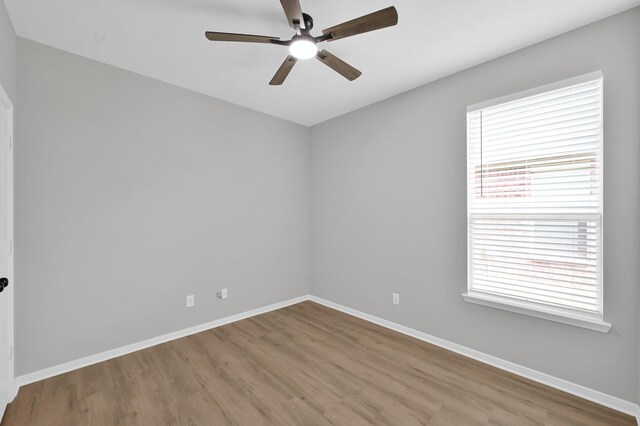 23911 Pinecreek Pt, Spring, TX 77373 - unfurnished room with a ceiling fan, wood finished floors, and plenty of natural light