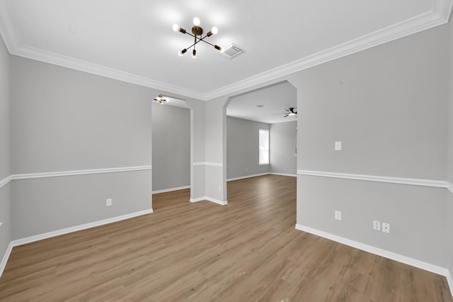 23911 Pinecreek Pt, Spring, TX 77373 - spare room with a chandelier, ceiling fan, wood finished floors, arched walkways, and ornamental molding