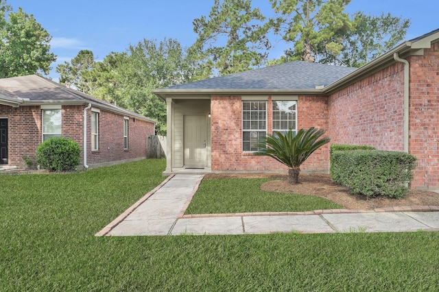 23911 Pinecreek Pt, Spring, TX 77373 - view of front of property featuring a front lawn, brick siding, and a shingled roof