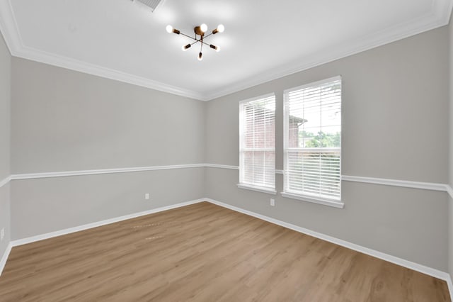23911 Pinecreek Pt, Spring, TX 77373 - empty room with a chandelier, light wood-type flooring, and ornamental molding