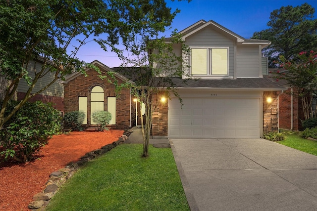 4303 Appalachian Trl, Houston, TX 77345 - traditional-style house featuring driveway, an attached garage, and brick siding