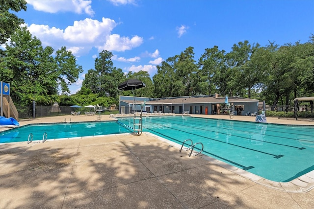 4303 Appalachian Trl, Houston, TX 77345 - community pool featuring a patio and view of wooded area